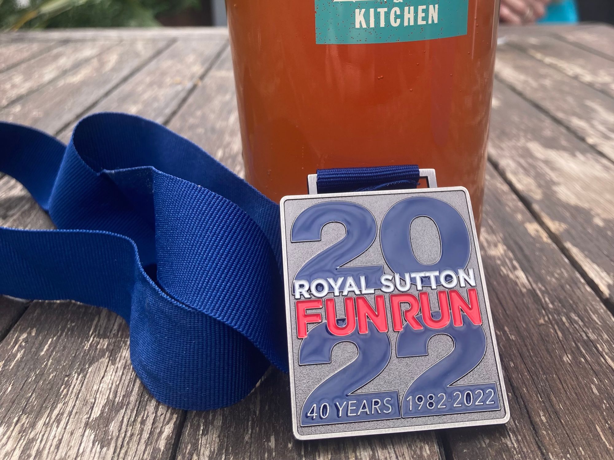 Pint of beer and Sutton Fun Run 2022 medal